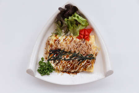 Japanese Omelette with Okonomiyaki Sauce Topping with Katsuobushi (dried, fermented, and smoked skipjack tuna), Seaweed and Mayonaise.の写真素材