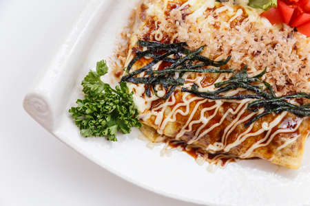Japanese Omelette with Okonomiyaki Sauce Topping with Katsuobushi (dried, fermented, and smoked skipjack tuna), Seaweed and Mayonaise.の写真素材