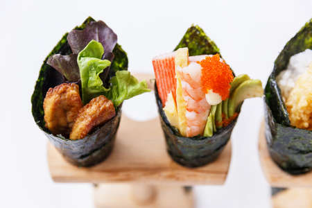 California Hand Roll Sushi Set : Foie Gras, Shrimp with Kani, Tamagoyaki, Avocado and Tobiko. Another is Shrimp Tempura and Crispy Tuna Skin with Sliced Cucumber.の写真素材