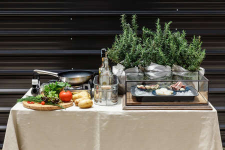 Outdoor Chef Table with Many Ingredients Include Vegetables, Pork, Beef, Scallop and Rosemary. With Pan and Gas Stove that Ready for Cook.の写真素材