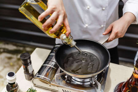 Chef Preparing Olive Oil in a Pan for Making Rosemary Oil.の写真素材