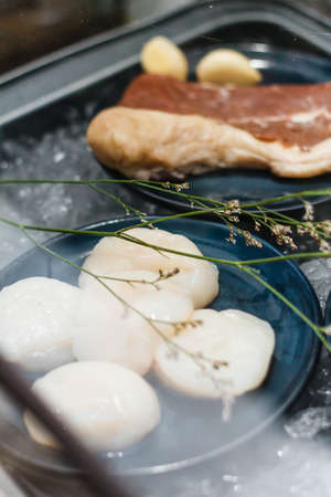 Beef and Scallop with Garlic on Iced Plate for Making Steaks in Glass Box.の写真素材