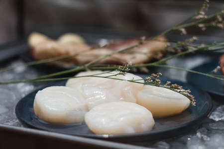 Beef and Scallop with Garlic on Iced Plate for Making Steaks in Glass Box.の写真素材