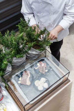 Chef Cut Rosemary Leaves by Knife for Making Rosemary Oil.の写真素材