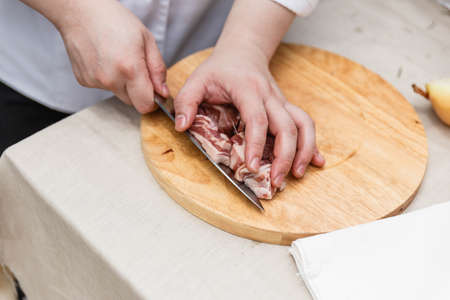 Chef Cutting Raw Meat on The Wood Block.の写真素材