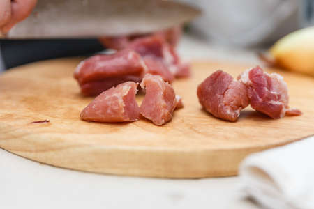 Chef Cutting Raw Meat on The Wood Block.の写真素材