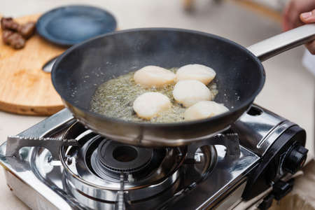 Chef Fried Scallops with Rosemary Oil in Pan with Spoon.の写真素材