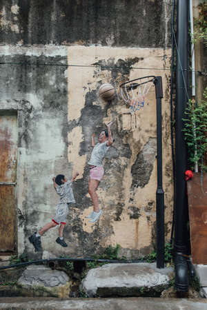 Painted Children Play Basketball on The Concrete Wall fro The Street of George Town. Penang, Malaysia.のeditorial素材