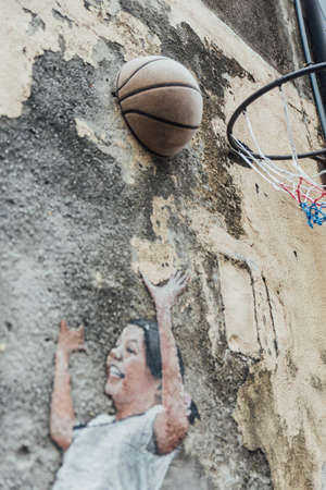 Detail of Painted Children Play Basketball on The Concrete Wall fro The Street of George Town. Penang, Malaysia.のeditorial素材