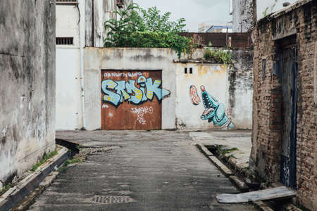 Graffiti on The Red Door with White Wall from The Street of George Town. Penang, Malaysia.のeditorial素材