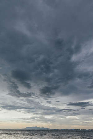 Seascape with Raining Cloud and Mountain at Dusk of George Town, Penang, Malaysia.の写真素材