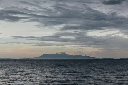 Seascape with Raining Cloud and Mountain at Dusk of George Town, Penang, Malaysia.の写真素材