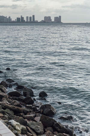 Raining in Park, near the Coast with Seascape and Cityscape of George Town, Penang, Malaysia.の写真素材