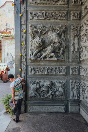 Stone carving wall that told about chinese fairy tales, in chinese temple at George Town. Penang, Malaysia.の写真素材