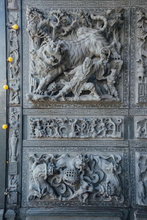 Stone carving wall that told about chinese fairy tales, in chinese temple at George Town. Penang, Malaysia.の写真素材
