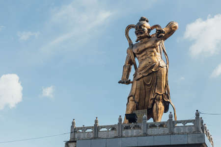 Golden Guanyin's guardian statue at octagonal pavilion in Kek Lok Si Temple at George Town. Panang, Malaysia.の写真素材