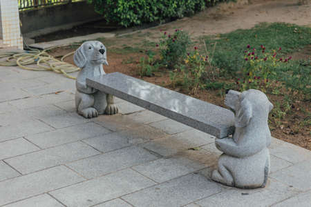 Stone carving seat with puppy sculptures at octagonal pavilion in Kek Lok Si Temple at George Town. Panang, Malaysia.の写真素材