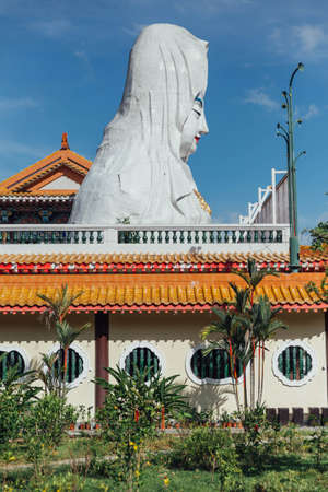 Enormous Guanyin statue over chinese style building at Kek Lok Si Temple at George Town. Panang, Malaysia.のeditorial素材