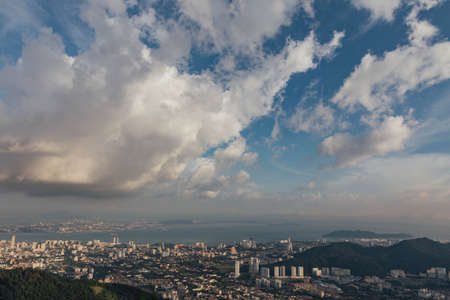 Cloudy sky, cityscape and mountain with green that viewed from Penang Hill at George Town. Penang, Malaysia.の写真素材