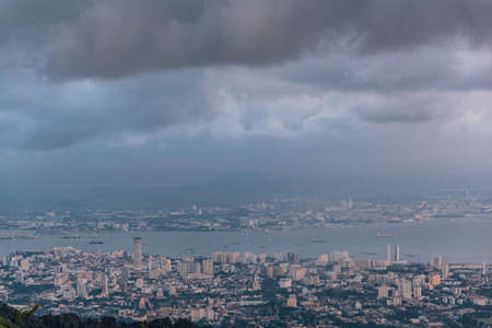 Dusk cloudy sky, cityscape and mountain with green that viewed from Penang Hill at George Town. Penang, Malaysia.の写真素材