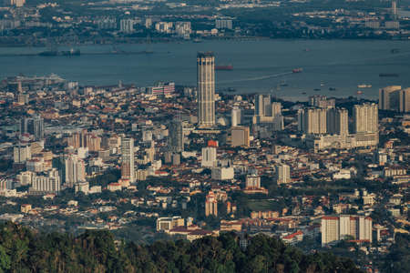 Dusk cloudy sky, cityscape and mountain with green that viewed from Penang Hill at George Town. Penang, Malaysia.の写真素材