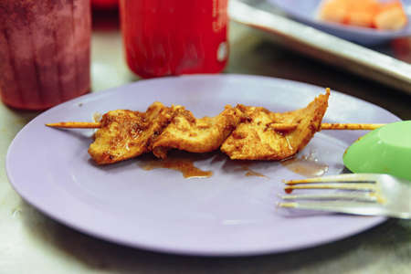 Finished pork stick with satay sauce. Satay is a dish of skewered grilled meat with Javanese origins in Malacca City, Malacca, Malaysia.の写真素材