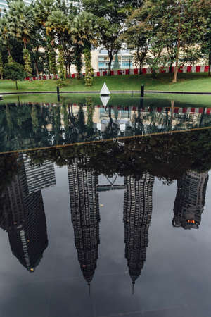 Petronas twin towers that reflected on the pool in Kuala Lumpur, Malaysia.のeditorial素材