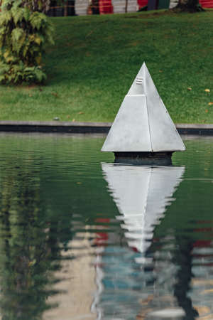 Steel Pyramid sculpture in the park's pool near Petronas twin towers in Kuala Lumpur, Malaysia.