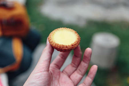 Egg tarts in hand in Kuala Lumnpur, Malaysia.の写真素材