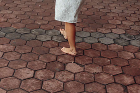Bared foot woman walk around Batu Caves entrance near Kuala Lumpur, Malaysiaの写真素材
