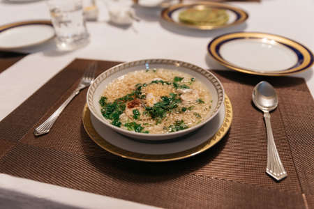 Boiled rice with pork and garlic in the bowl on dinning table.の写真素材