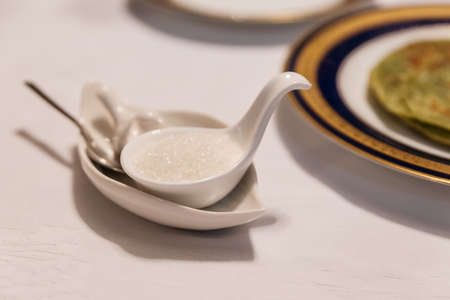 A cup of sugar on the dinning table.の写真素材