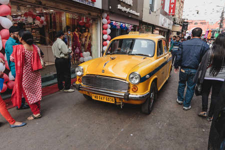 Yellow vintage taxi in Kolkata, India.