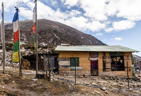 Rural grocery store. Wall made by weaving woods and door made by fabric with mountain in the background at Thangu and Chopta valley in winter in Lachen. North Sikkim, India.のeditorial素材
