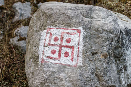Swastika sign on grey stone at Thangu and Chopta valley in winter in Lachen. North Sikkim, India.のeditorial素材
