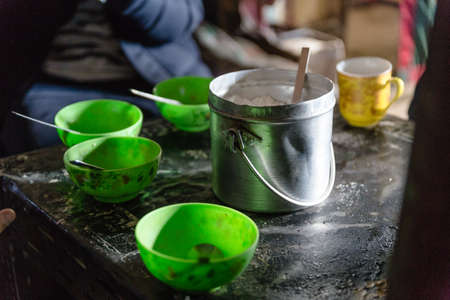 Indian horlicks powder in stainless steel bucket with green cups on the table in grocery store at Thangu and Chopta valley in winter in Lachen. North Sikkim, India.の写真素材