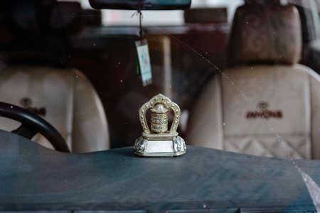 Tibetan automatic prayer wheel in the front of tourist car at Lachung in winter. North Sikkim, India.の写真素材