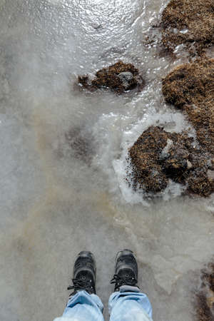 Tourist stand on frozen pond