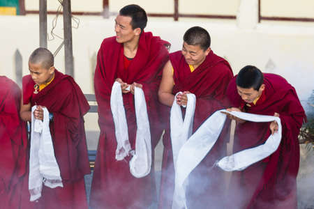 Tibetan monks bowing with frankincense smoke for welcoming high level monk in area of Rumtek Monastery near Gangtok. Sikkim, Indiaのeditorial素材