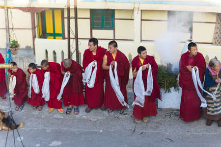 Tibetan monks bowing with frankincense smoke for welcoming high level monk in area of Rumtek Monastery near Gangtok. Sikkim, Indiaのeditorial素材