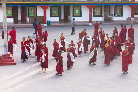 Tibetan young monks walk and play in front of Rumtek Monastery after high level monk arrived near Gangtok. Sikkim, Indiaのeditorial素材