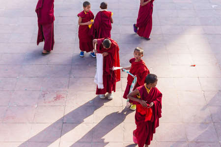 Tibetan young monks walk and play in front of Rumtek Monastery after high level monk arrived near Gangtok. Sikkim, Indiaのeditorial素材