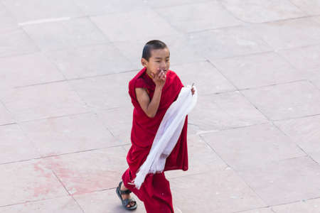 Tibetan young monks walk and play in front of Rumtek Monastery after high level monk arrived near Gangtok. Sikkim, Indiaのeditorial素材