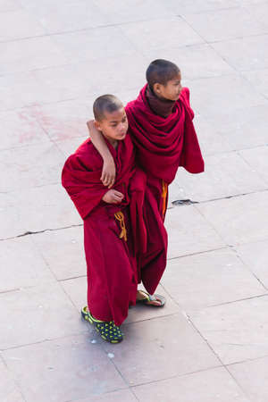 Tibetan young monks walk and play in front of Rumtek Monastery after high level monk arrived near...