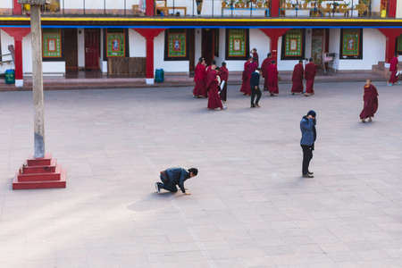 Tibetan Buddhist tourist bow his body in front of Rumtek Monastery after high level monk arrived near Gangtok. Sikkim, Indiaのeditorial素材