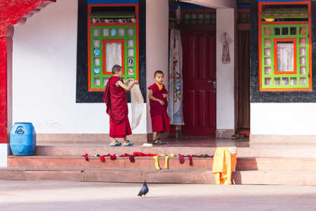 Tibetan young monks stand in front of cubicle of Rumtek Monastery in winter near Gangtok. Sikkim, India.のeditorial素材