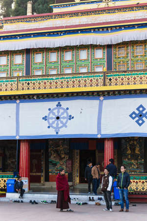 Tourist talk with Tibetan monk in front of Rumtek Monastery in winter near Gangtok. Sikkim, India.のeditorial素材