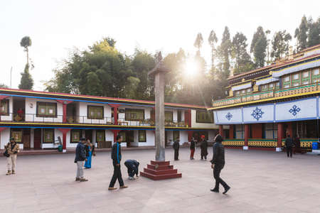 Tourists toss many coin to the top of stone pillar for lucky  in the center of Rumtek Monastery in winter near Gangtok. Sikkim, India.のeditorial素材