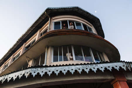 Tourists in the building are seeing the the first light in the dawn of new year's day from window at Tiger Hill, Darjeeling. India.のeditorial素材