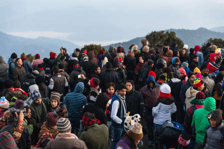 Crowded people are waiting for the first light in the dawn of new year's day with mountain and fog in background at Tiger Hill, Darjeeling. India.のeditorial素材
